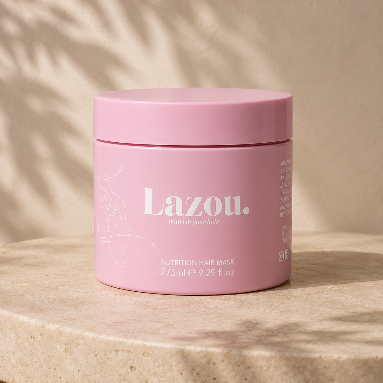 Pink jar of Lazou hair mask on a beige surface with soft shadows